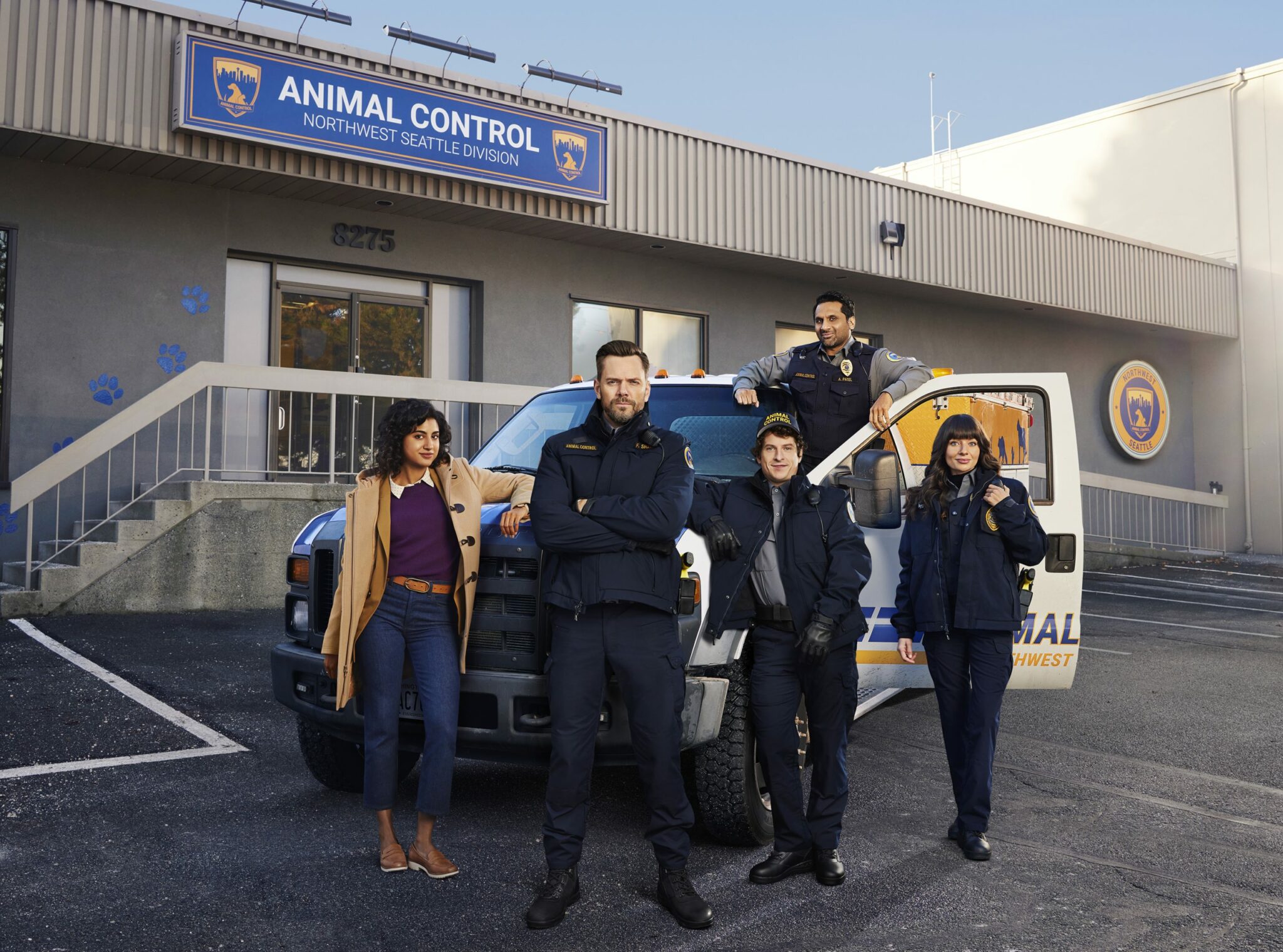 Animal Control, L-R: Emily (Vella Lovell), Frank (Joel McHale), Shred (Michael Rowland), Amit Patel (Ravi V. Patel), whom I've included both names because some characters call him "Amit" and others call him "Patel", Victoria (Grace Sands) - outside the precinct in front of a truck