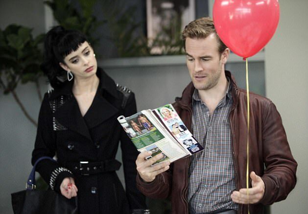 Krysten Ritter and Van Der Beek look at a magazine together.